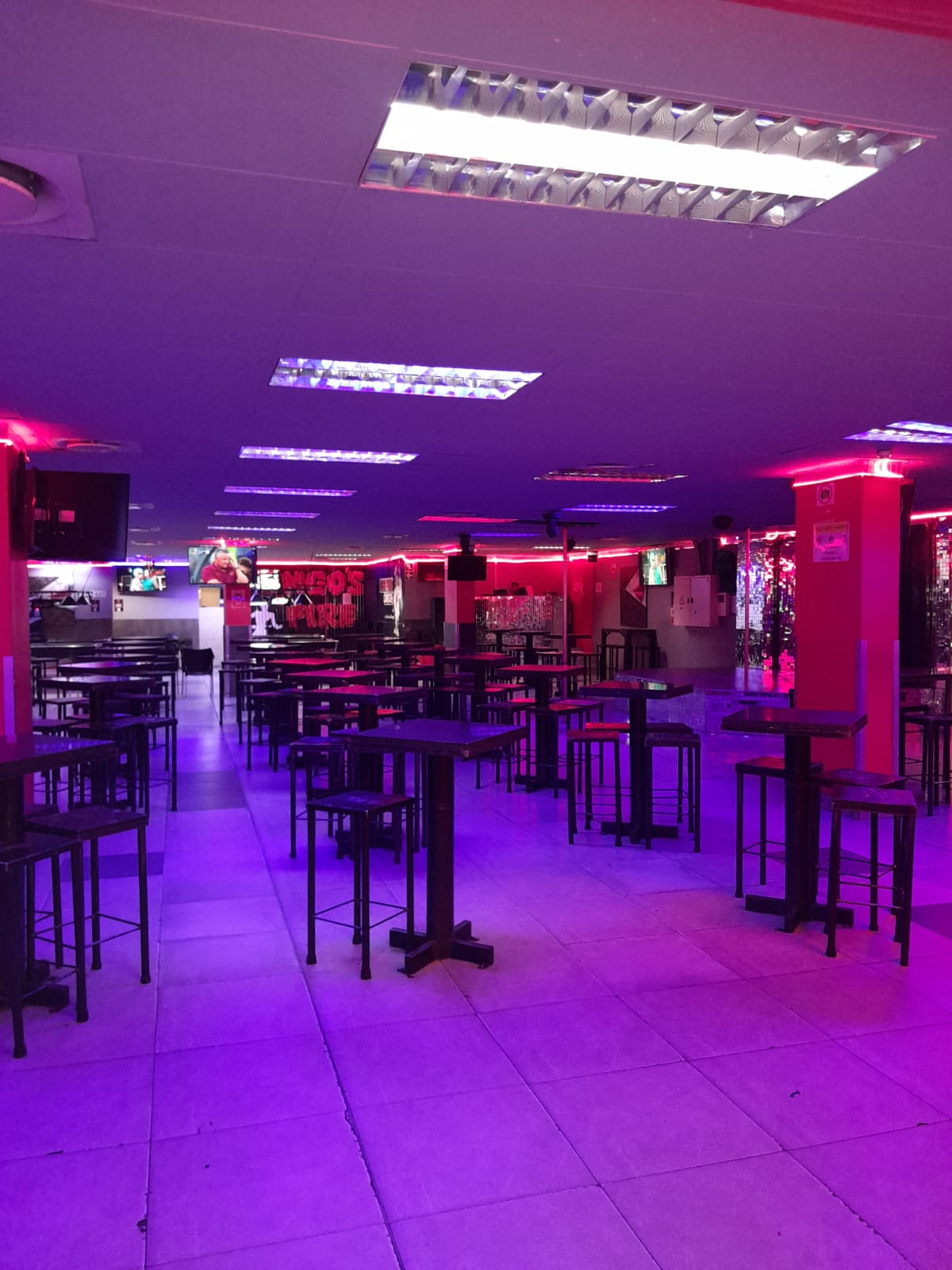 Main hall seating under purple neon at Cheeky Tiger Randburg
