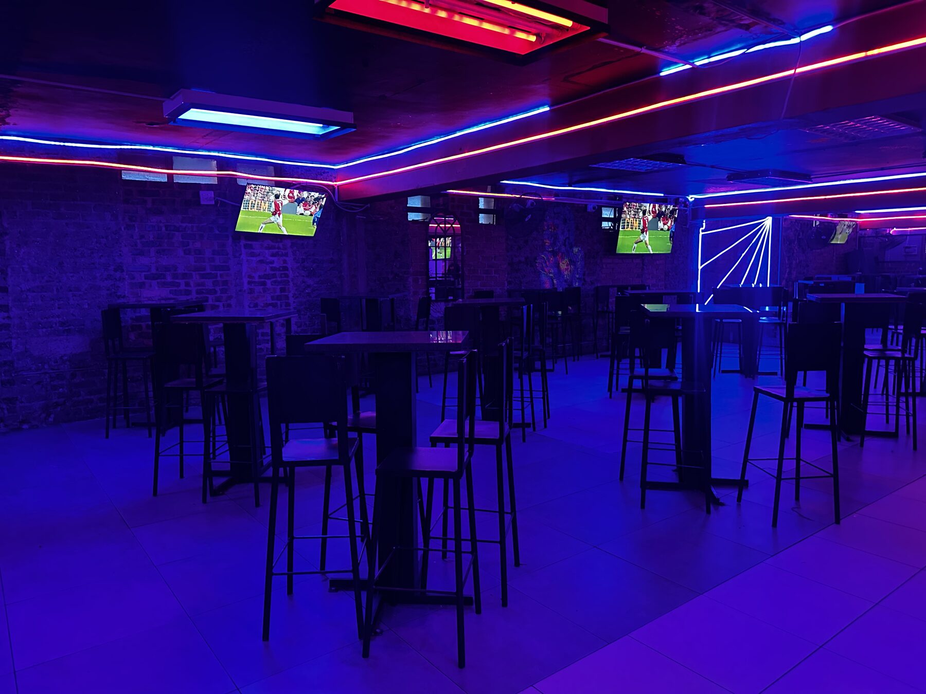 Lounge seating under red and blue neon ceiling strips at Cheeky Tiger Diepkloof Hotel