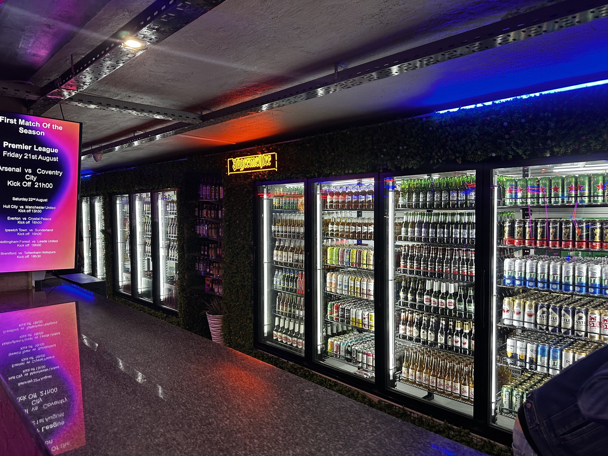 Bar counter with fully stocked beer and cider fridges at Cheeky Tiger Midrand