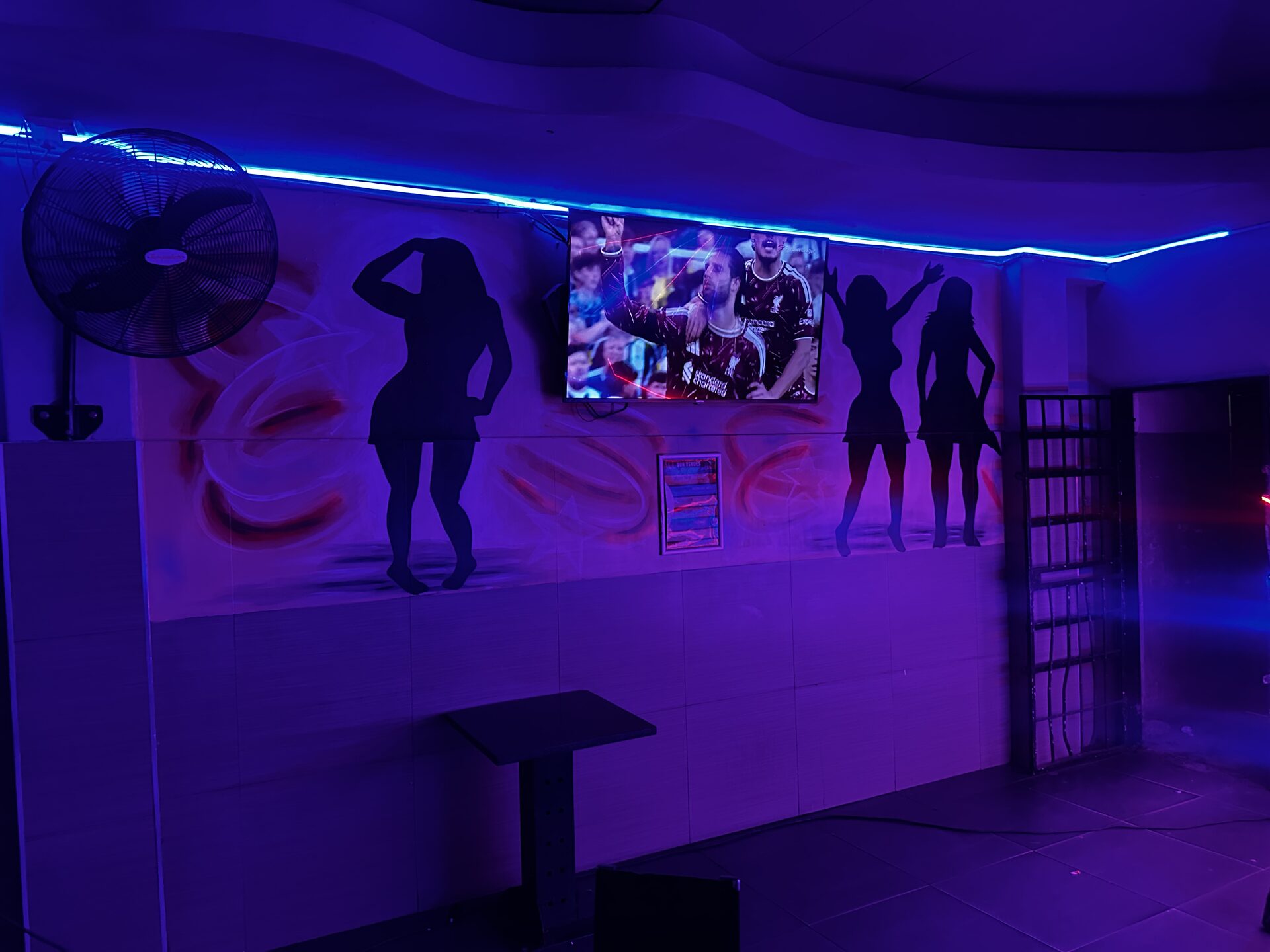 Dancer silhouette mural wall under blue neon at Cheeky Tiger Kempton Park