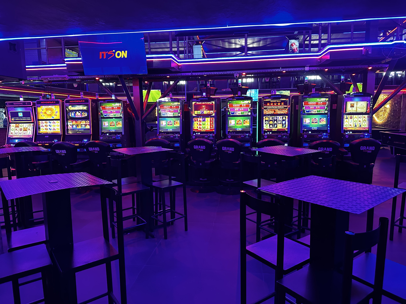 Admiral and Novostar slot machines behind the Grand Bar high tables at Cheeky Tiger Midrand