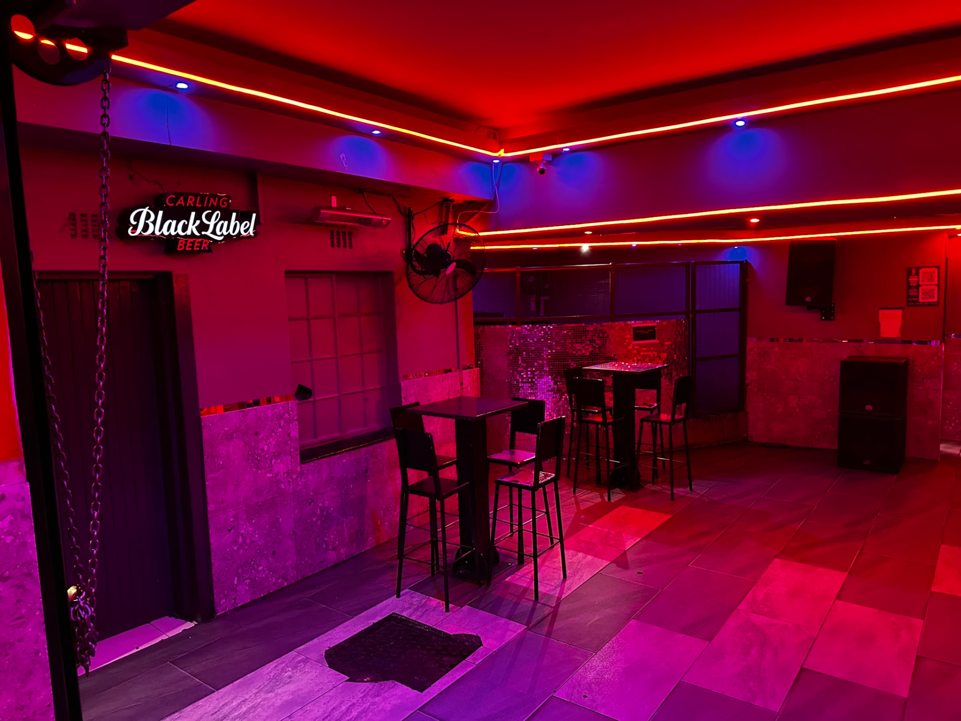 Red neon lounge with high tables at Cheeky Tiger Germiston