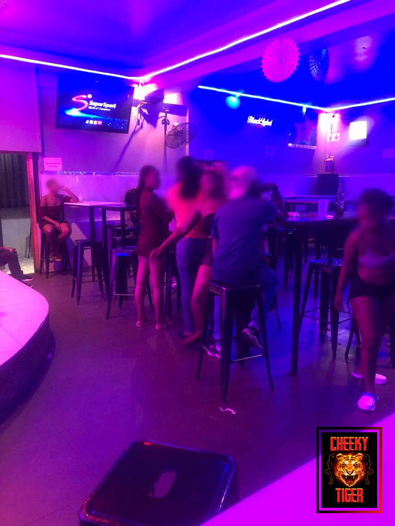 Guests at high tables beside the stage at Cheeky Tiger Noord Street