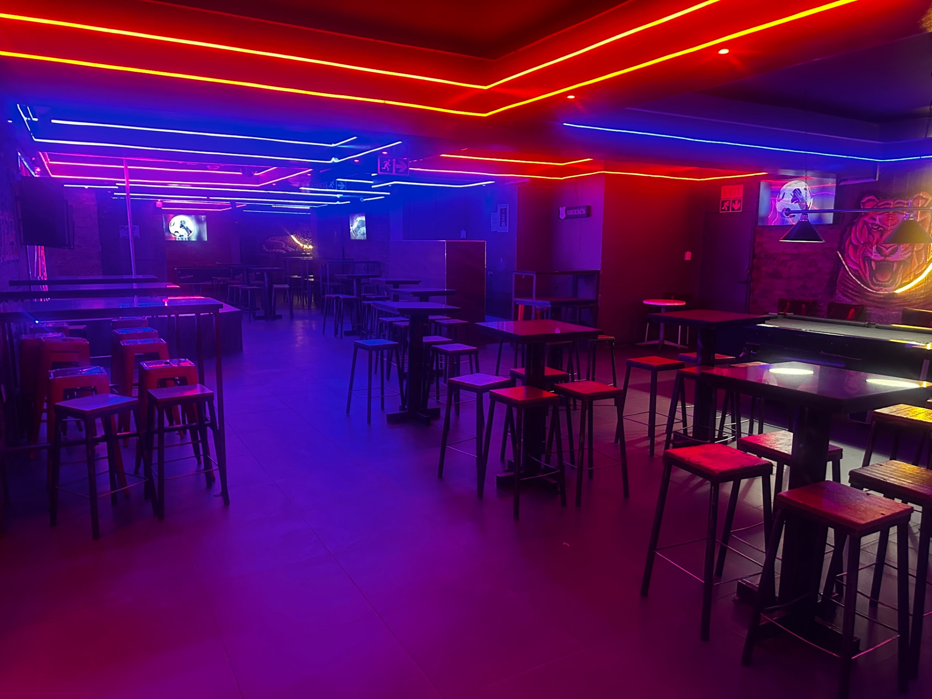 Cheeky Tiger Bree Street main floor with neon ceiling and tiger mural
