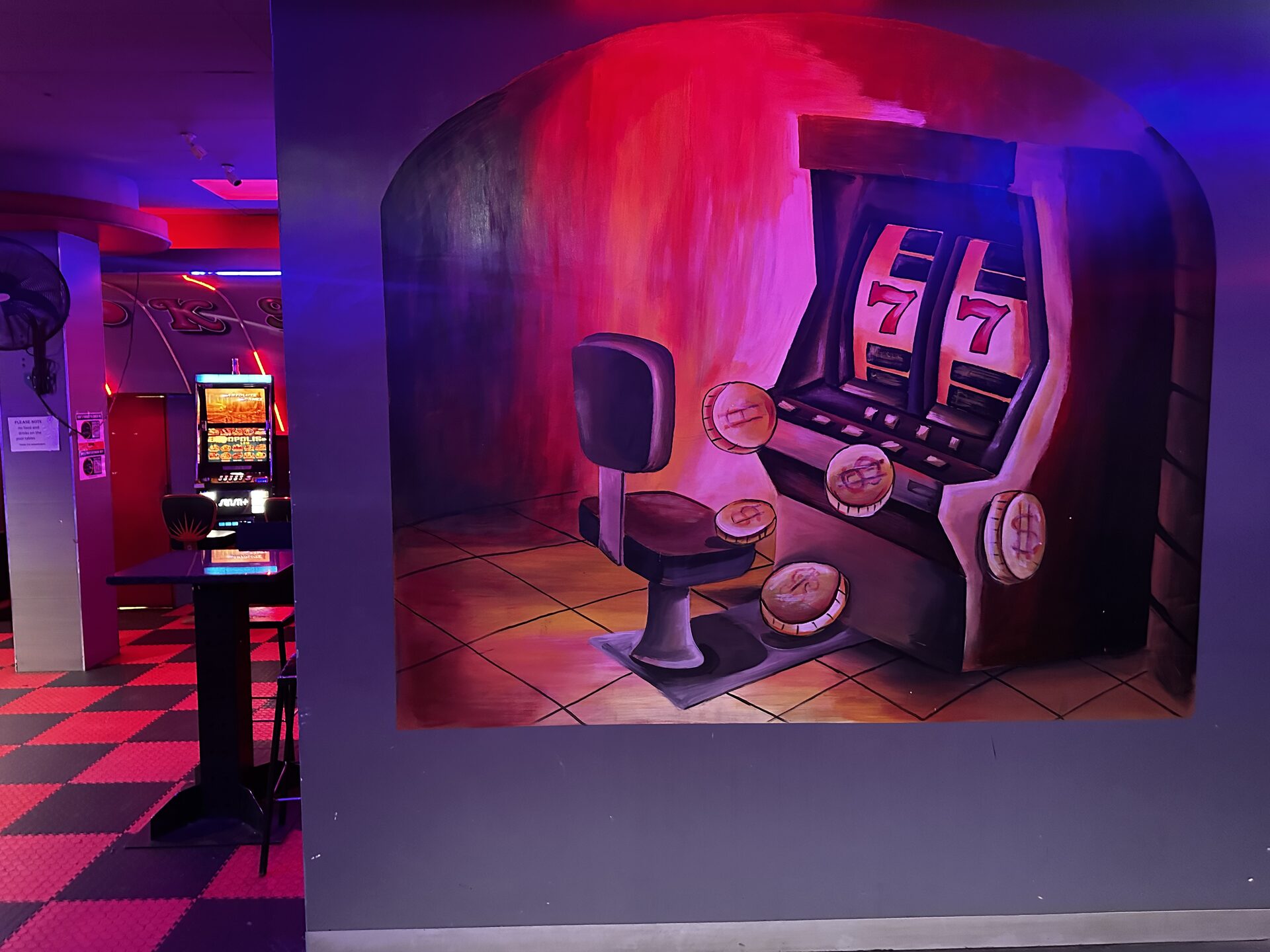 Painted slot machine mural beside the gaming floor at Cheeky Tiger Kempton Park
