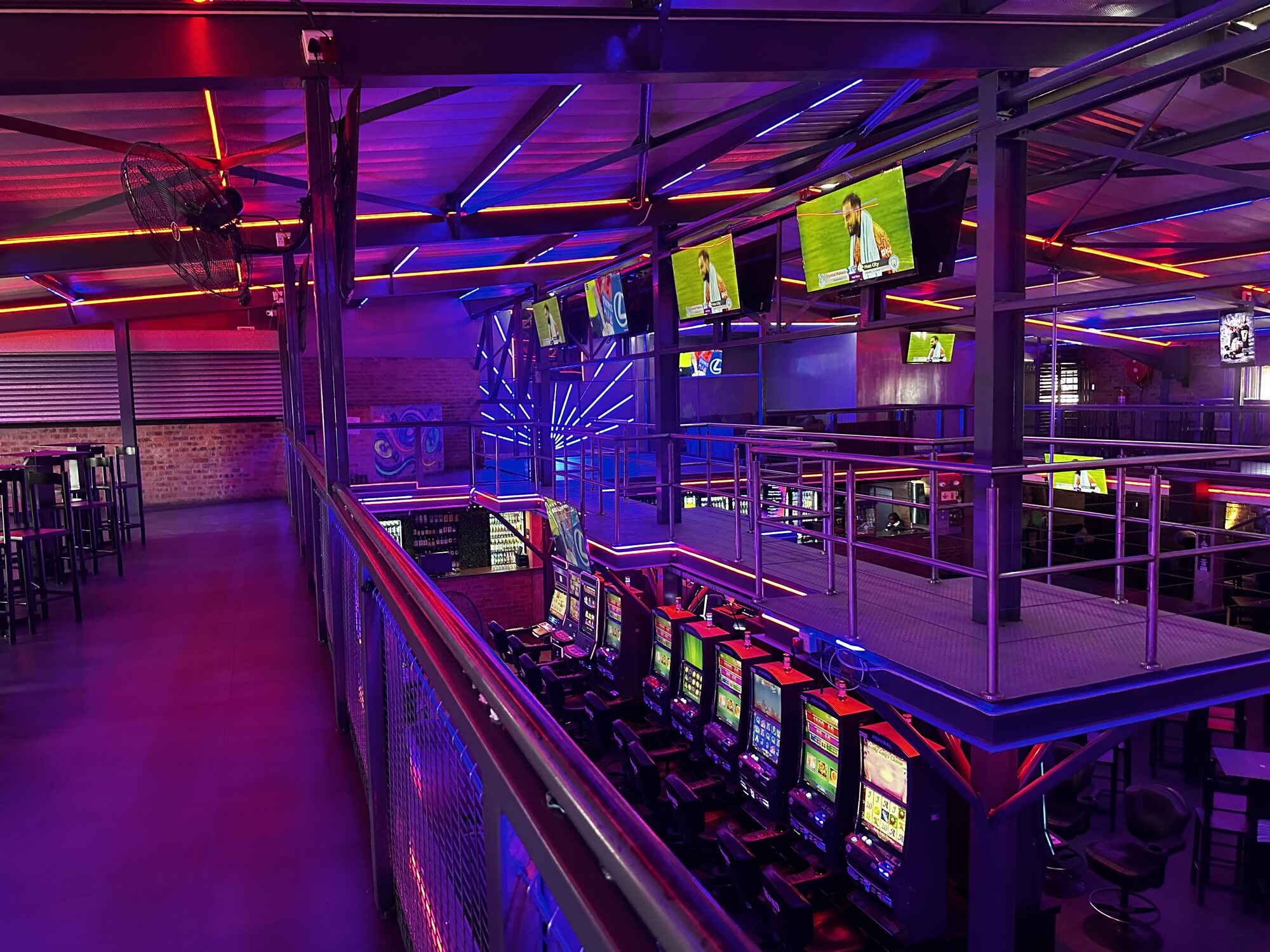 Mezzanine view across the main hall and big-screen sports wall at Cheeky Tiger Midrand