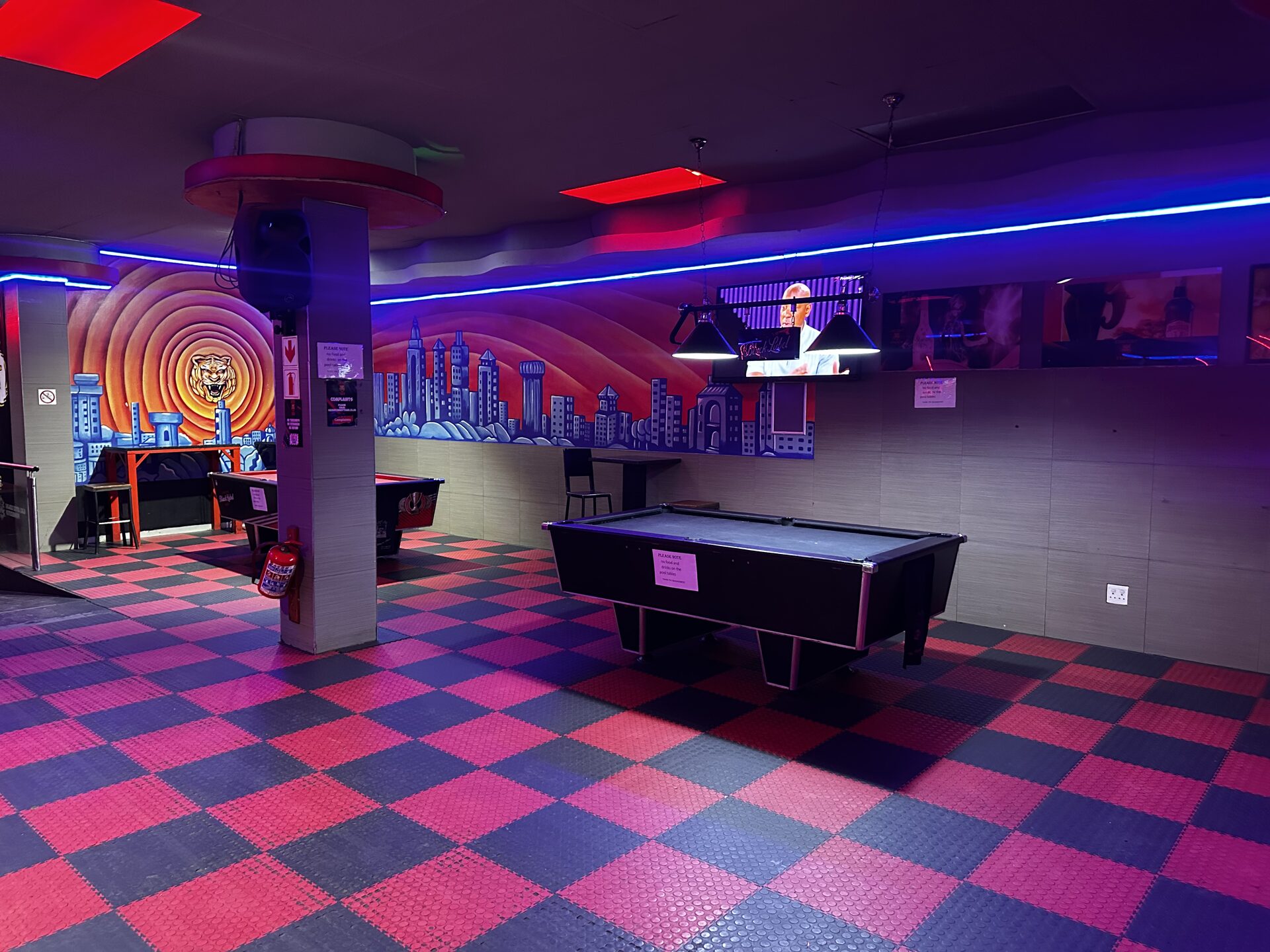 Pool lounge with pool tables and a hand-painted city skyline mural at Cheeky Tiger Kempton Park