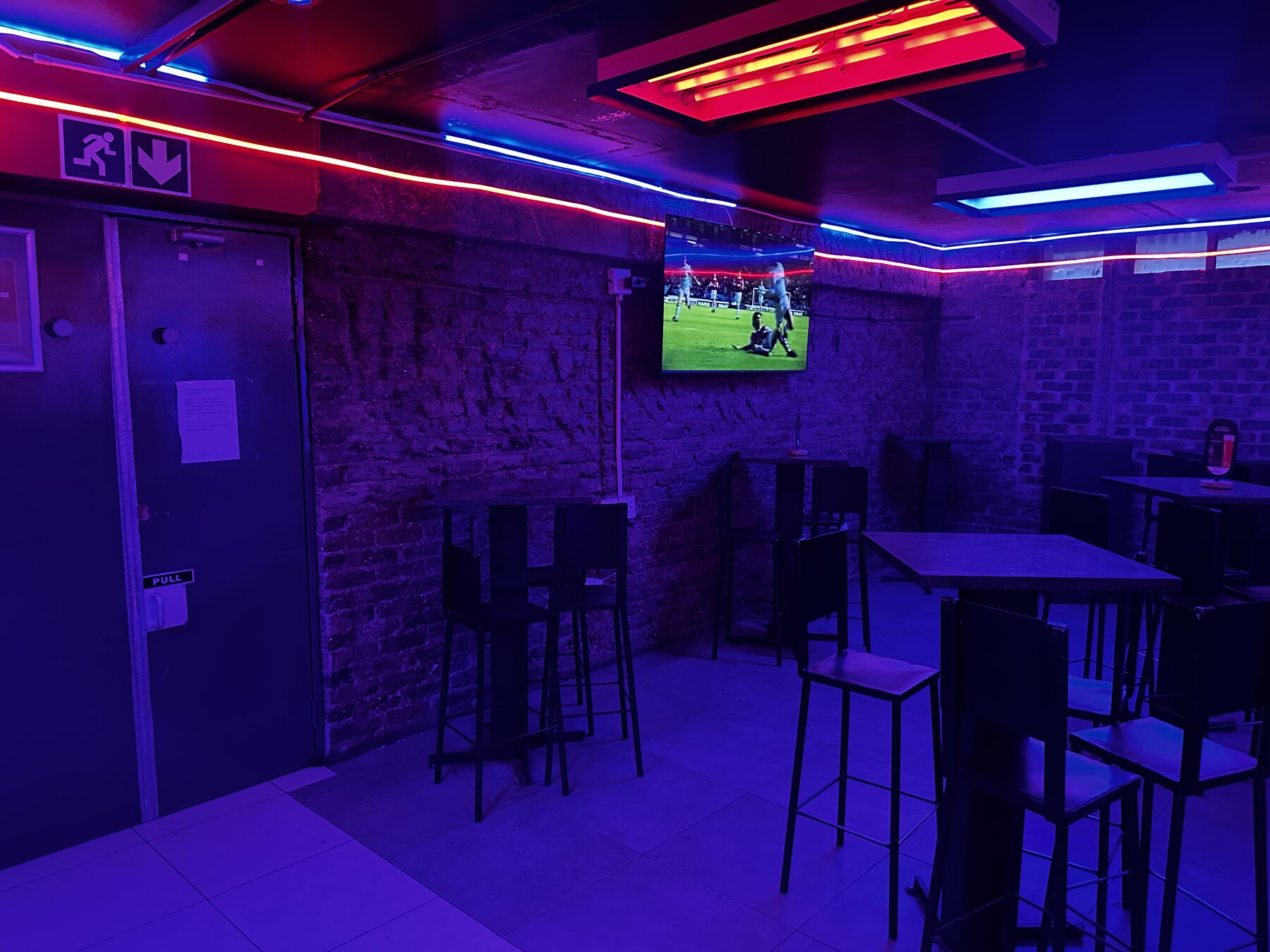 Big-screen sports lounge with high tables at Cheeky Tiger Diepkloof Hotel
