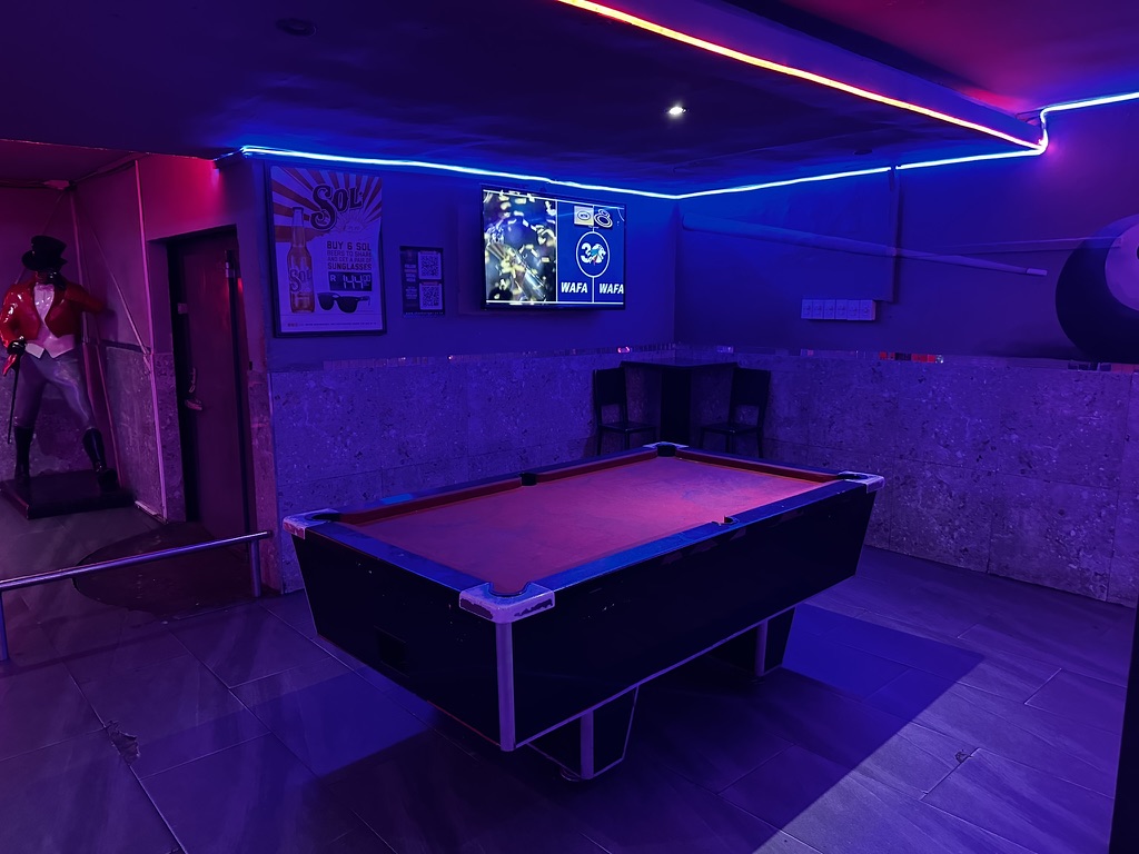 Pool lounge under blue and red neon at Cheeky Tiger Germiston