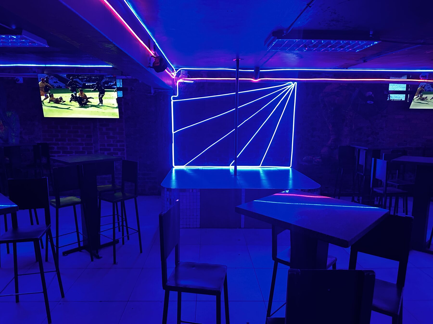 Neon laser feature wall beside the sports screens at Cheeky Tiger Diepkloof Hotel