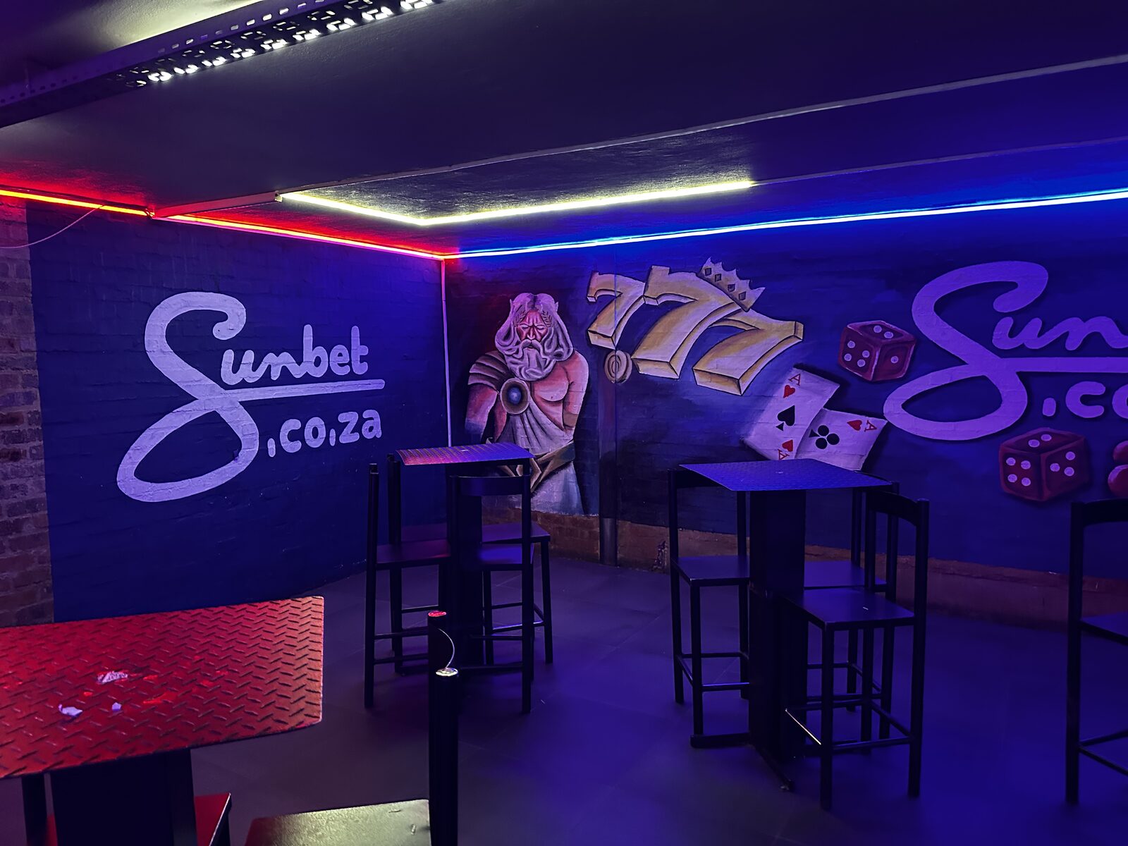 Corner seating beside the Sunbet 777 mural at Cheeky Tiger Midrand